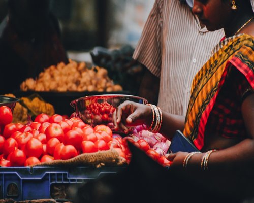 A Pakistani man picking out fresh vegetables at a local market in Lahore